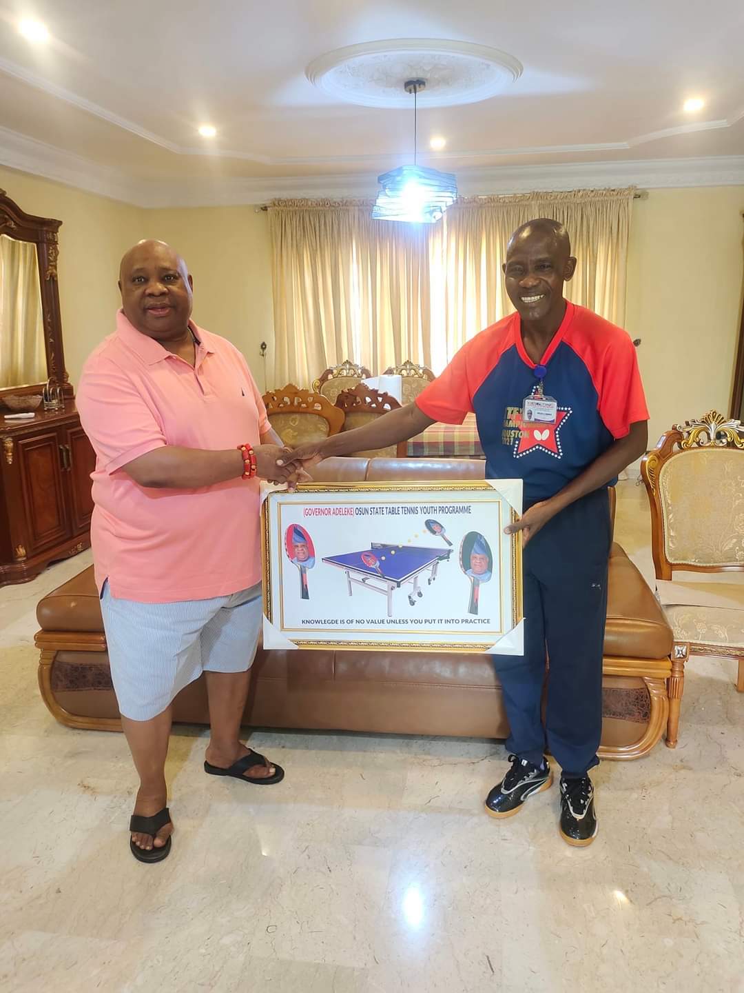 VSO Director presenting a framed Osun State Table Tennis Youth Programme plaque to Governor Adeleke